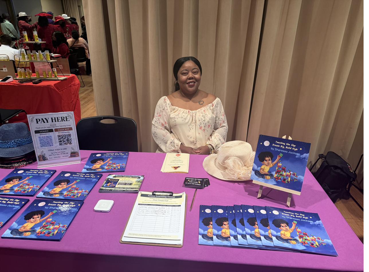 Sheressa at her book table meeting readers