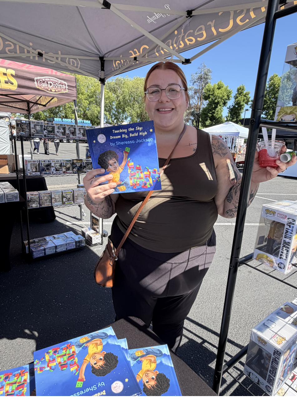 Reader smiling with the book at a market