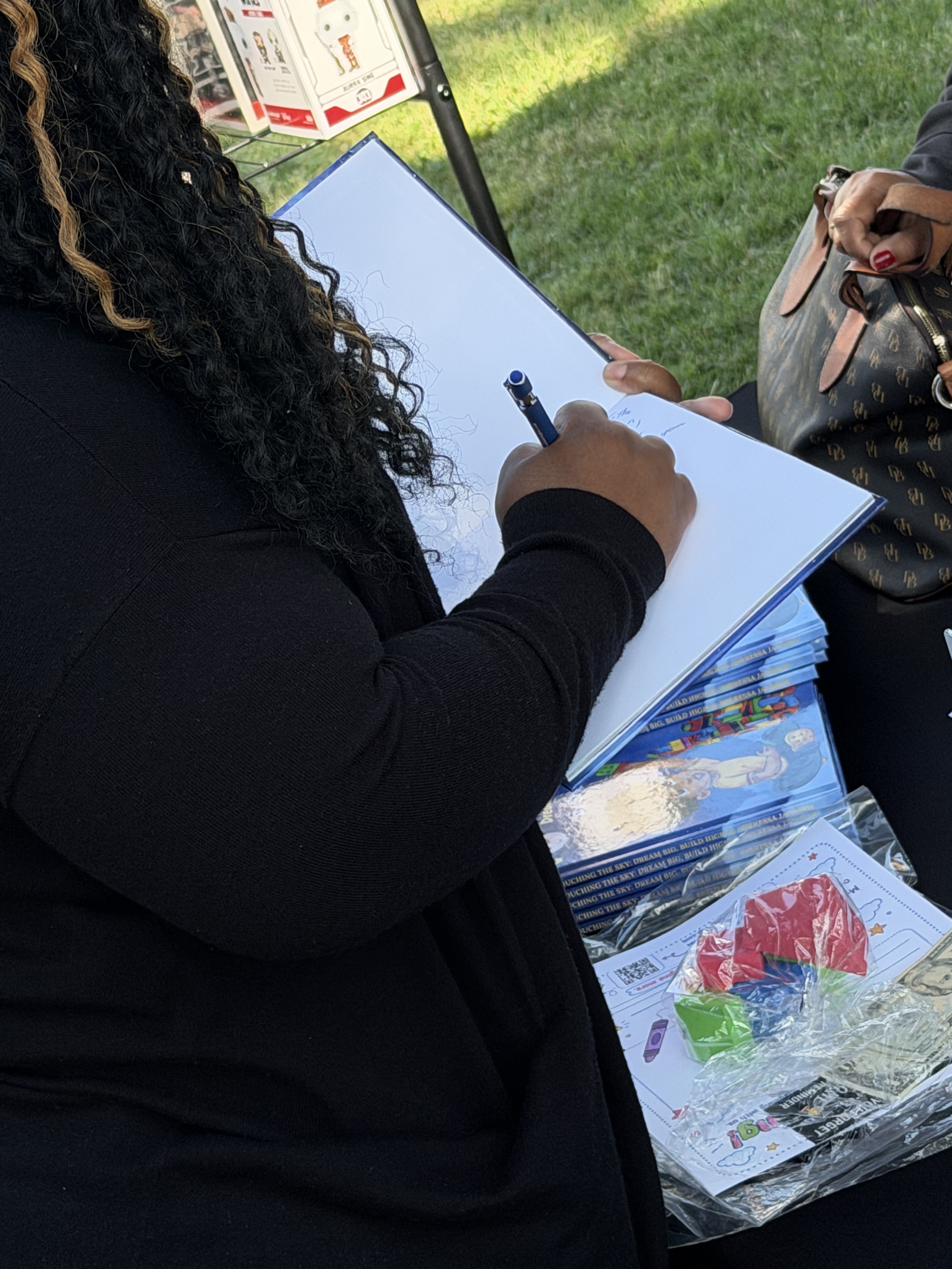 Sheressa signing a copy of her book